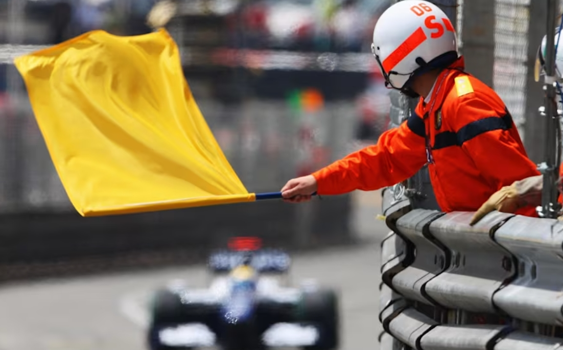 Yellow caution flag displayed at an F1 marshal post