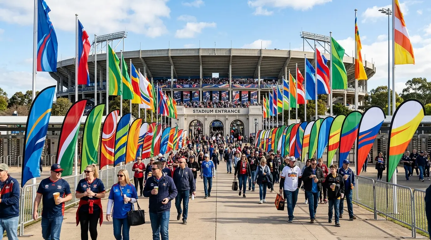 Feather flags and teardrop flags lining the entrance of an outdoor sports stadium