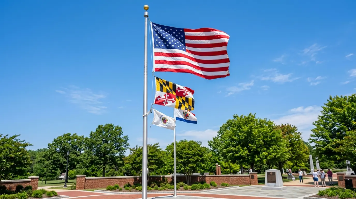 Multiple flags on a single pole with American flag at top and smaller state flag below showing proper size hierarchy